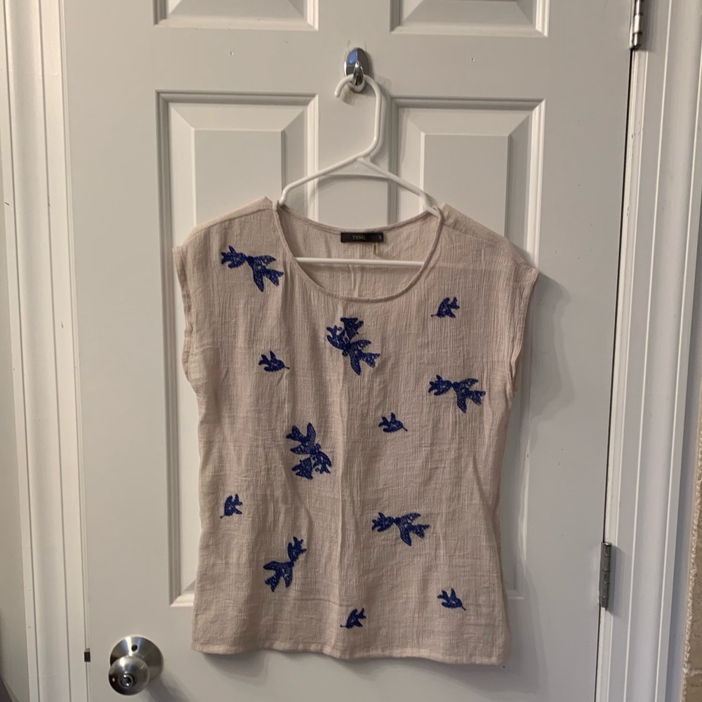 Size small light weight beige top with blue embroidered design